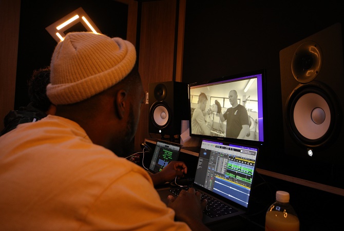 A man producing the Boxer Beat video in a recording studio