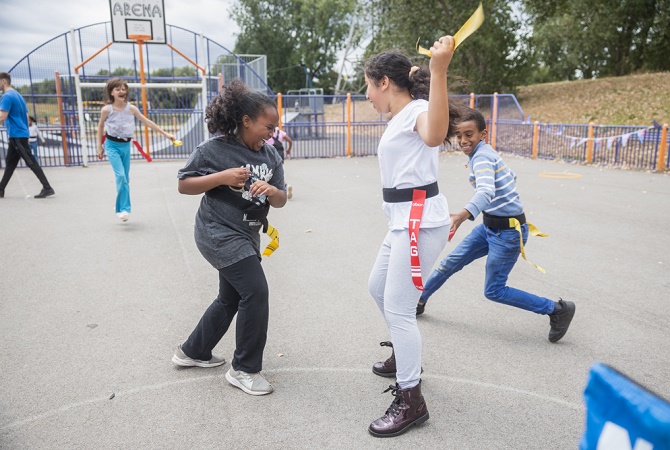 A group of children playing tag rugby