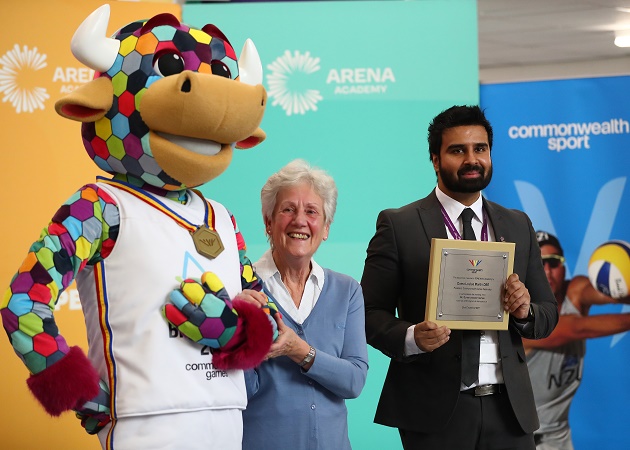 Commonwealth Games Federation President Dame Louise Martin giving a commemorative plaque to Arena Academy Headteacher Raj Mann. Also in picture is Games mascot Perry