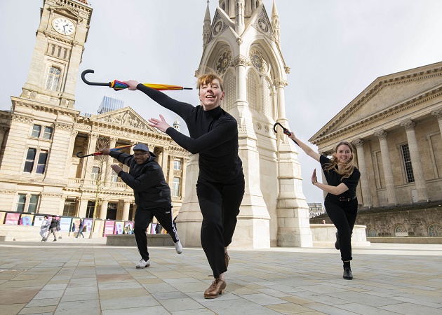 Three dancers celebrate the launch of the Birmingham 2022 Festival in Chamberlain Square, Birmingham
