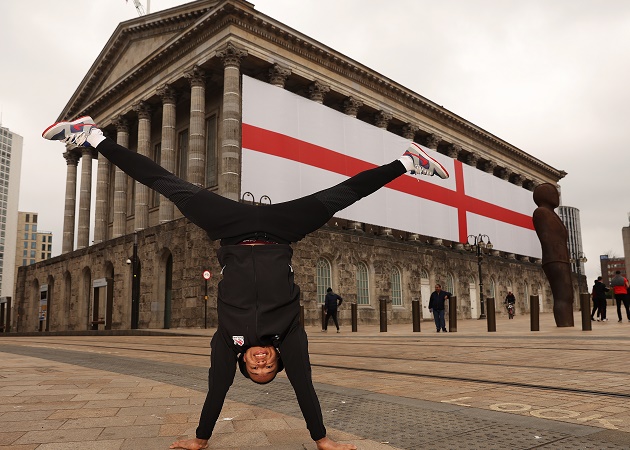 Team England gymnast Joe Fraser performs a handstand outside Birmingham Town Hall