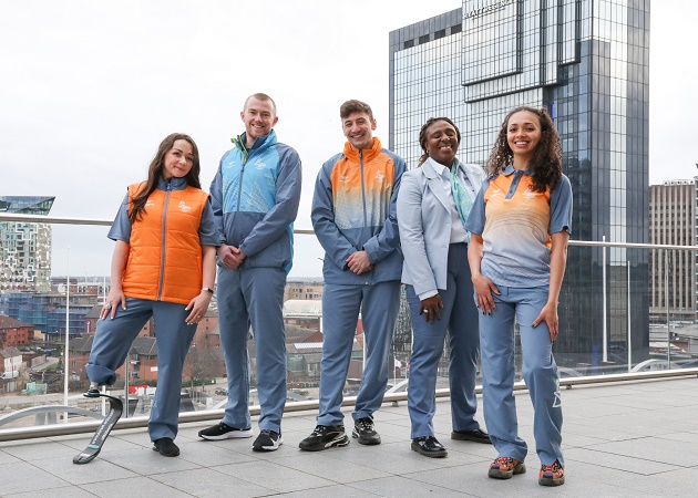 A group of five people wearing the new Commonwealth Collective uniforms