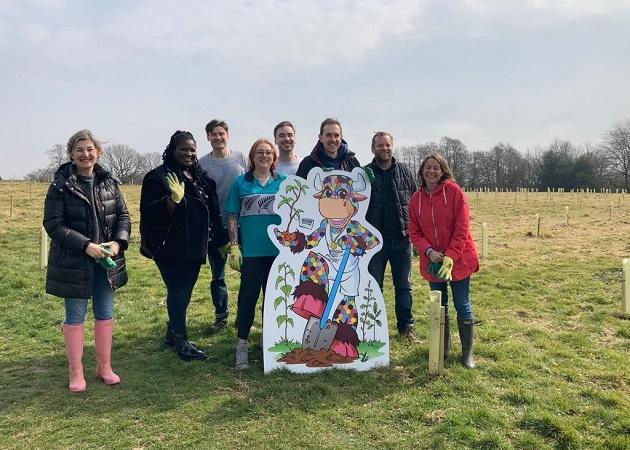 Volunteers pose with cut out of Perry the Commonwealth Games mascot as they gather at Woodgate Valley Country park to plant 6,000 trees