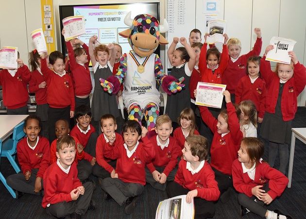 Junior school children around the CWG mascot celebrating the launch of new key stage one and two resources for schools.